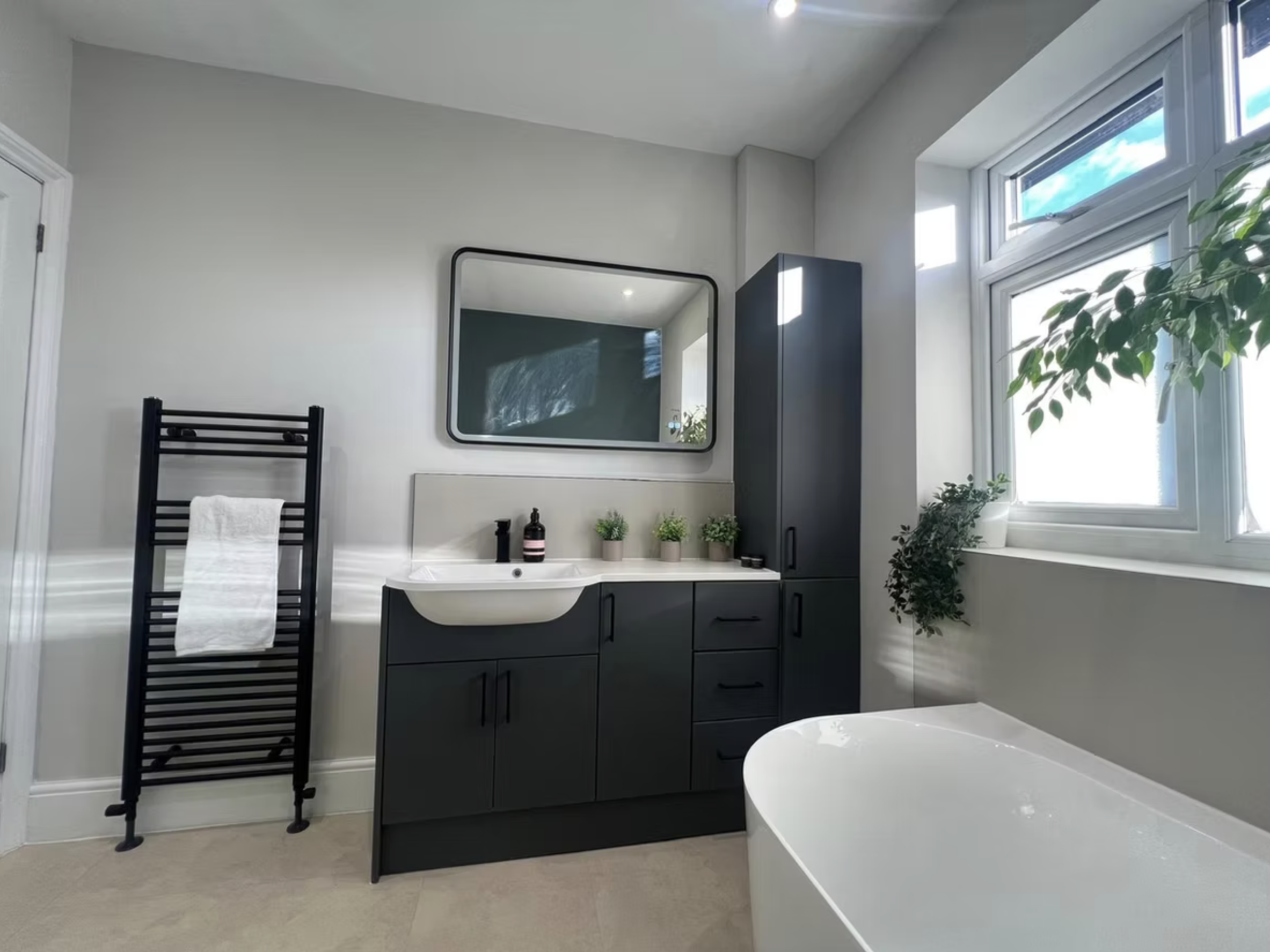 The charcoal vanity, basin and black-framed mirror in the Green Bathroom.